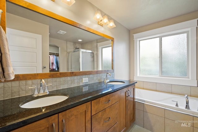 9462 W Whitecrest, Star, ID 83669 - bathroom featuring double vanity, a shower stall, tasteful backsplash, a walk in closet, and a garden tub