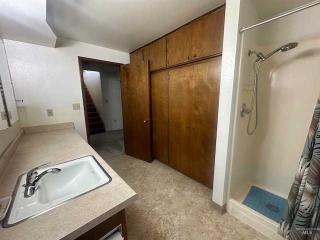 bathroom with vanity, concrete flooring, and a shower with shower curtain