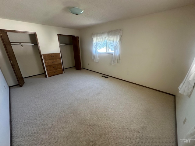 unfurnished bedroom featuring light carpet