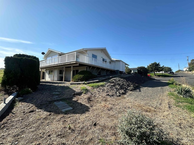 view of home's exterior featuring a wooden deck