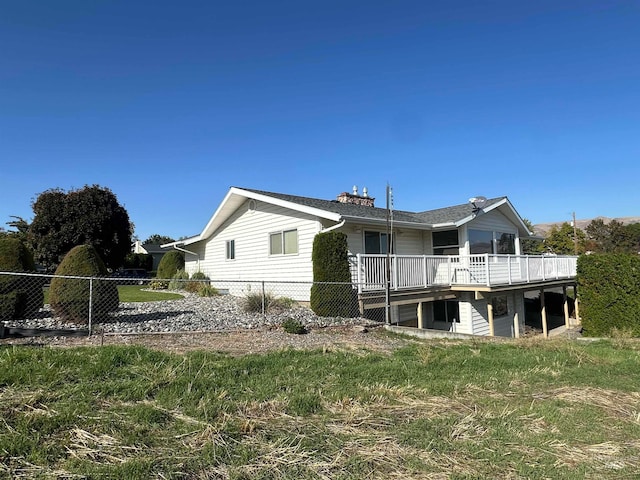 rear view of property featuring a deck