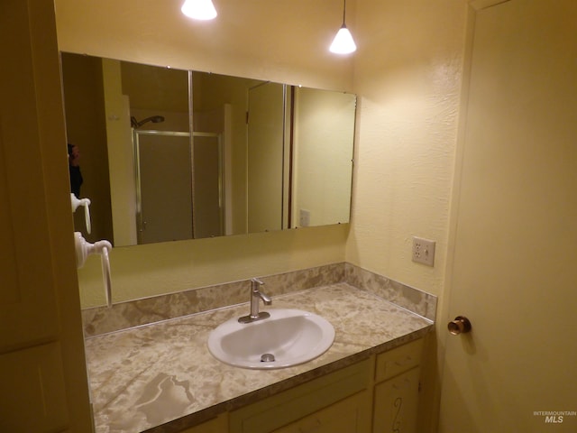 bathroom with vanity and walk in shower