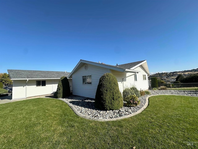 view of side of property with a yard