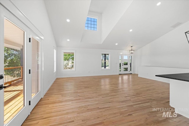 1006 Hill Rd, Homedale, ID 83628 - unfurnished living room with a towering ceiling, light wood finished floors, and recessed lighting