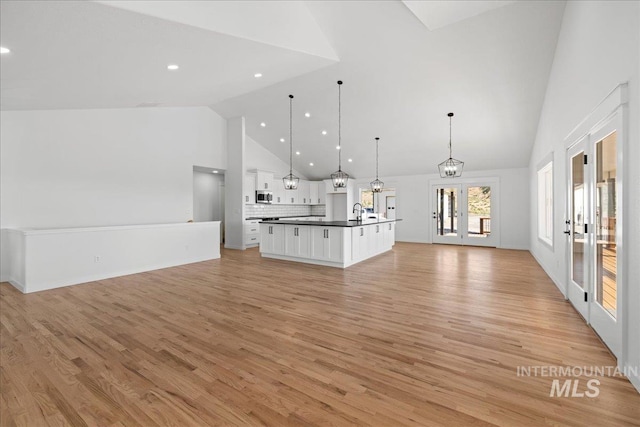1006 Hill Rd, Homedale, ID 83628 - unfurnished living room featuring french doors, high vaulted ceiling, light wood-style floors, and recessed lighting