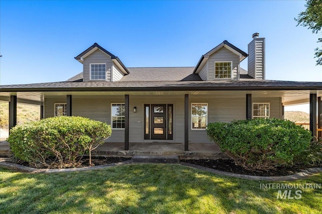 1006 Hill Rd, Homedale, ID 83628 - view of front of home featuring a front yard, covered porch, a chimney, and a shingled roof