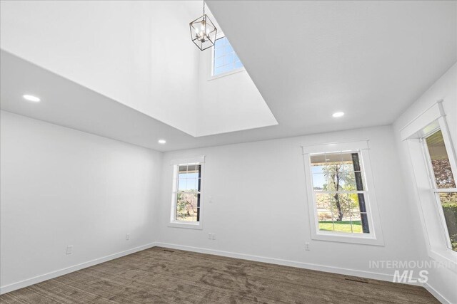 1006 Hill Rd, Homedale, ID 83628 - spare room with recessed lighting, dark carpet, and a chandelier