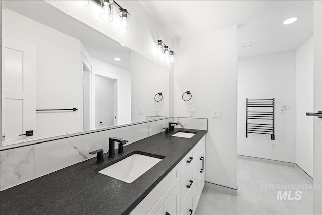1006 Hill Rd, Homedale, ID 83628 - bathroom with recessed lighting, double vanity, tile patterned floors, and a towel warmer