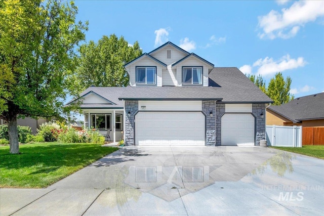 583 E Willowridge Ct, Kuna, ID 83634 - view of front of house featuring driveway, stone siding, an attached garage, and a shingled roof