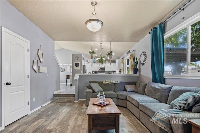 583 E Willowridge Ct, Kuna, ID 83634 - living area featuring wood finished floors, baseboards, and vaulted ceiling