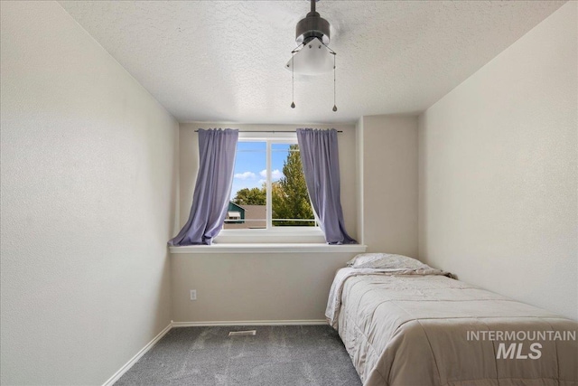 583 E Willowridge Ct, Kuna, ID 83634 - carpeted bedroom featuring baseboards and a textured ceiling