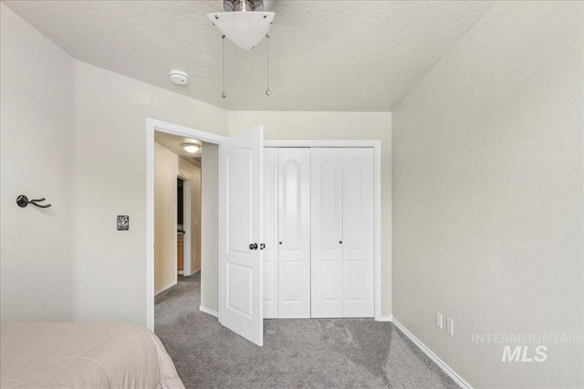 583 E Willowridge Ct, Kuna, ID 83634 - unfurnished bedroom with carpet flooring, baseboards, a closet, and a textured ceiling