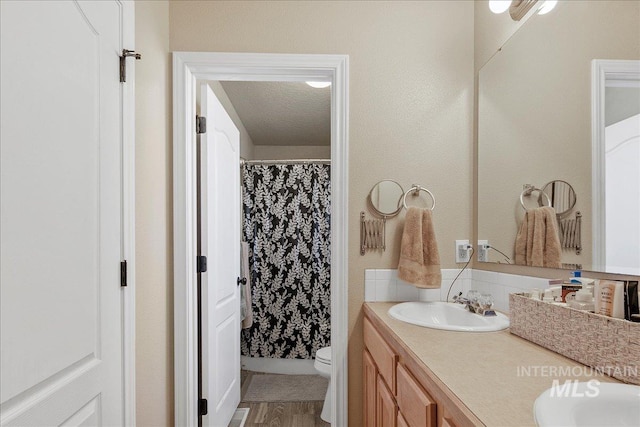 583 E Willowridge Ct, Kuna, ID 83634 - bathroom featuring double vanity, toilet, wood finished floors, and a shower with curtain