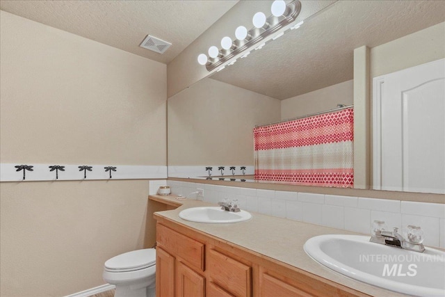 583 E Willowridge Ct, Kuna, ID 83634 - full bathroom with double vanity, toilet, tasteful backsplash, a textured ceiling, and a shower with curtain