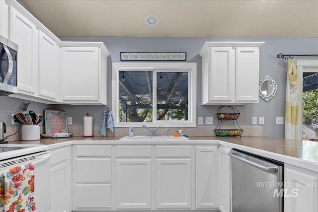 583 E Willowridge Ct, Kuna, ID 83634 - kitchen featuring appliances with stainless steel finishes, a sink, white cabinets, and light countertops