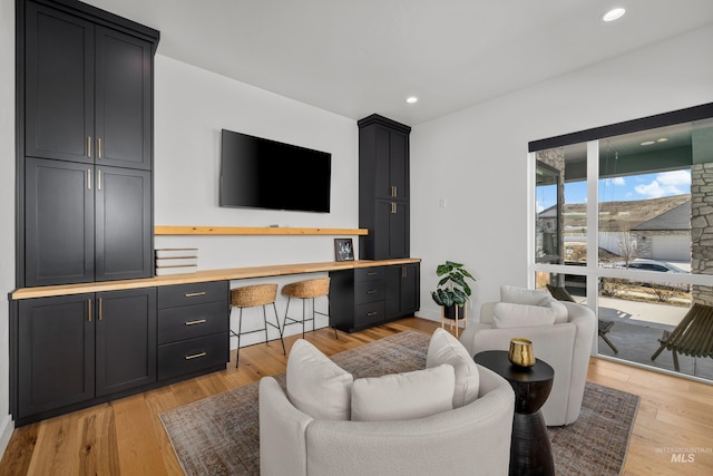 13684 N Sage Grouse Pl, Boise, ID 83714 - living room with recessed lighting, light wood-style flooring, and built in desk