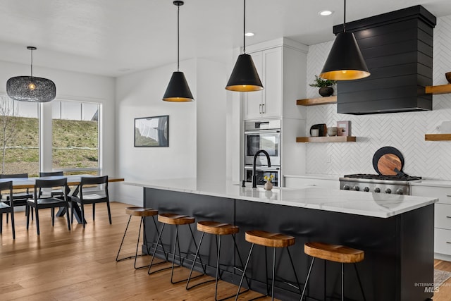 13684 N Sage Grouse Pl, Boise, ID 83714 - kitchen with open shelves, light wood-style floors, double oven, and ventilation hood