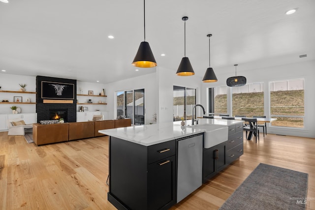 13684 N Sage Grouse Pl, Boise, ID 83714 - kitchen featuring a sink, stainless steel dishwasher, a healthy amount of sunlight, and dark cabinets