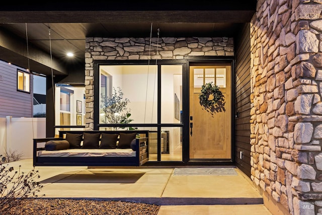 entrance to property featuring stone siding