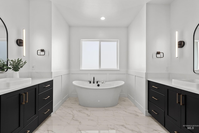 13684 N Sage Grouse Pl, Boise, ID 83714 - full bathroom with a sink, a freestanding bath, marble finish floor, and wainscoting