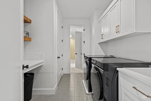13684 N Sage Grouse Pl, Boise, ID 83714 - laundry room with baseboards, cabinet space, washing machine and dryer, and light tile patterned flooring