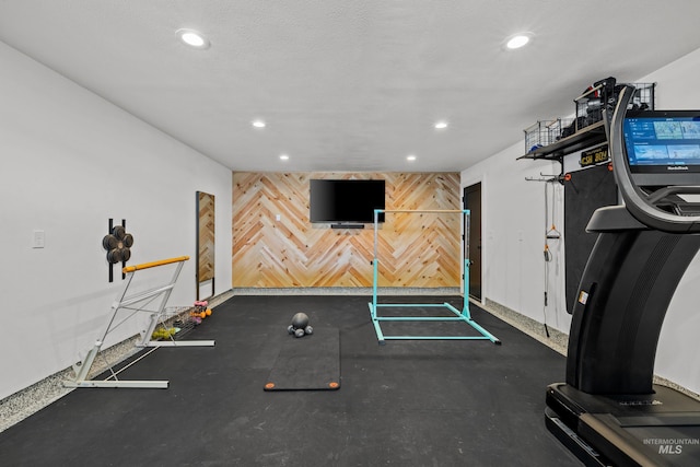13684 N Sage Grouse Pl, Boise, ID 83714 - exercise area with a textured ceiling, recessed lighting, wood walls, baseboards, and an accent wall