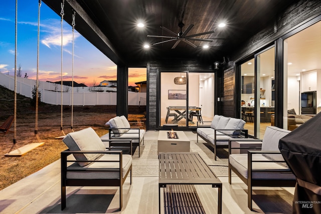 13684 N Sage Grouse Pl, Boise, ID 83714 - patio terrace at dusk with an outdoor living space with a fire pit, fence, and ceiling fan