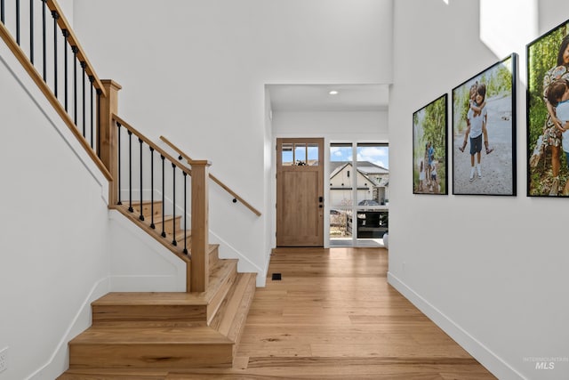 13684 N Sage Grouse Pl, Boise, ID 83714 - foyer entrance with baseboards, light wood-style floors, a high ceiling, and stairs
