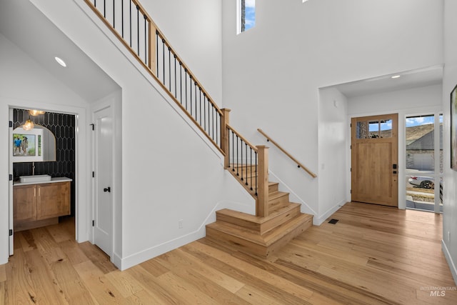 13684 N Sage Grouse Pl, Boise, ID 83714 - foyer with a healthy amount of sunlight, stairs, light wood-type flooring, and a high ceiling