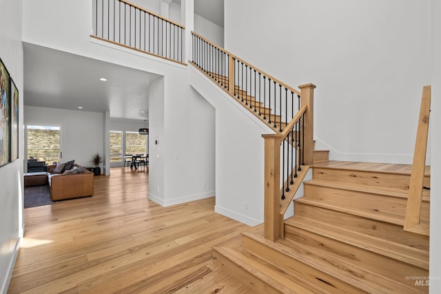 13684 N Sage Grouse Pl, Boise, ID 83714 - stairs featuring recessed lighting, baseboards, hardwood / wood-style floors, and a towering ceiling