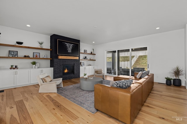 13684 N Sage Grouse Pl, Boise, ID 83714 - living room featuring a brick fireplace, recessed lighting, and light wood-type flooring