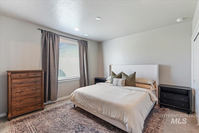 carpeted bedroom with baseboards, recessed lighting, and visible vents