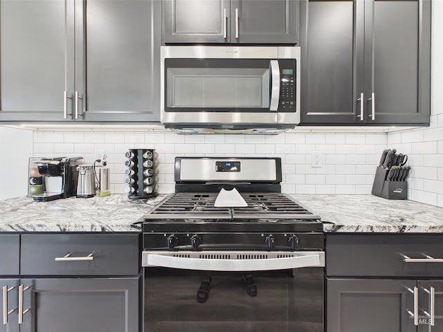 2420 Great Basin Way, Burley, ID 83318 - kitchen with stainless steel microwave, gas stove, tasteful backsplash, and gray cabinets