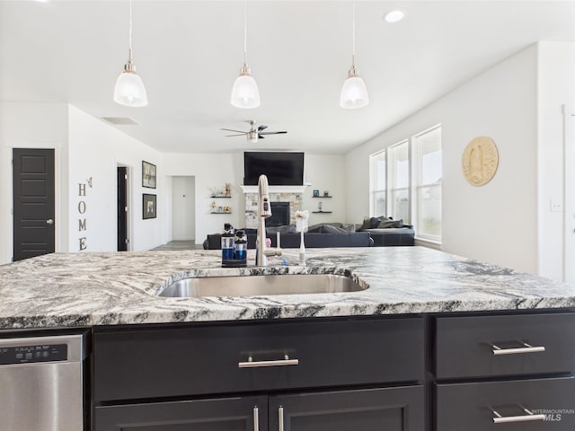 2420 Great Basin Way, Burley, ID 83318 - kitchen with stainless steel dishwasher, a sink, a ceiling fan, and light stone counters