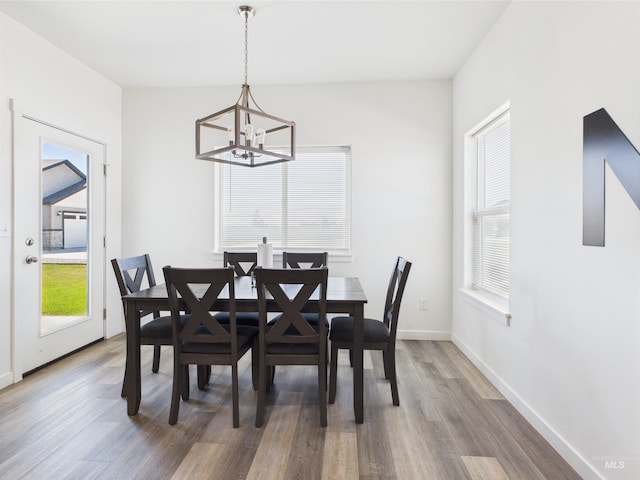 2420 Great Basin Way, Burley, ID 83318 - dining room featuring a chandelier, wood finished floors, and baseboards