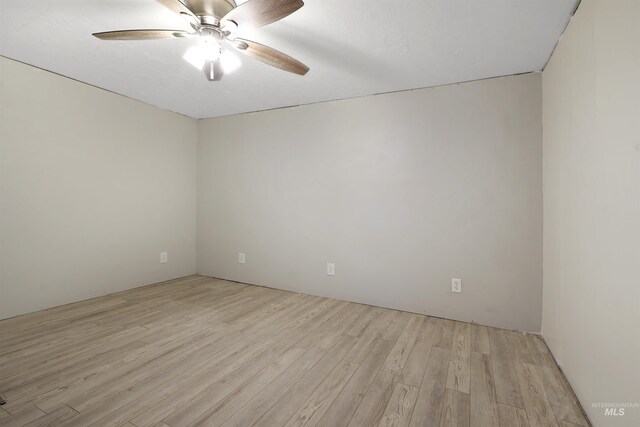 spare room featuring ceiling fan and light hardwood / wood-style flooring