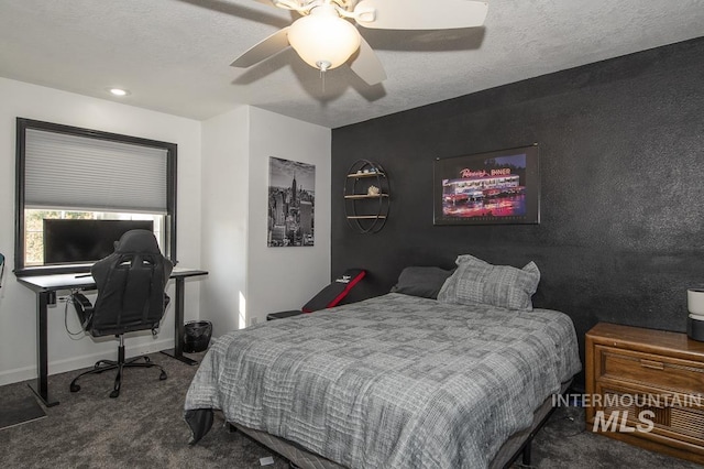 carpeted bedroom featuring ceiling fan, a textured ceiling, and baseboards