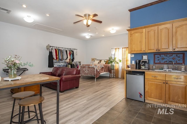 kitchen featuring a sink, visible vents, a ceiling fan, open floor plan, and dishwasher