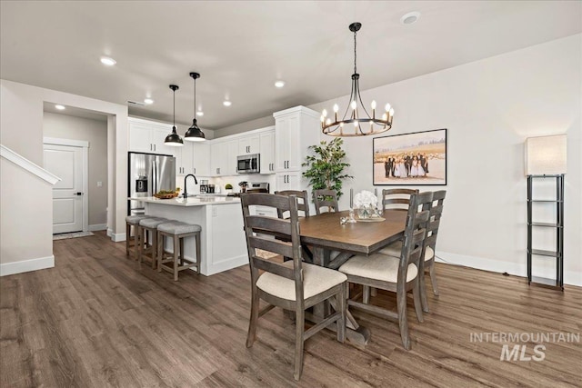 205 S Ripplerock Ln, Star, ID 83669 - dining area with dark wood-type flooring, recessed lighting, baseboards, and a chandelier