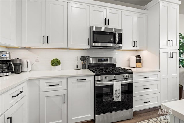 205 S Ripplerock Ln, Star, ID 83669 - kitchen featuring appliances with stainless steel finishes, white cabinets, light countertops, and tasteful backsplash