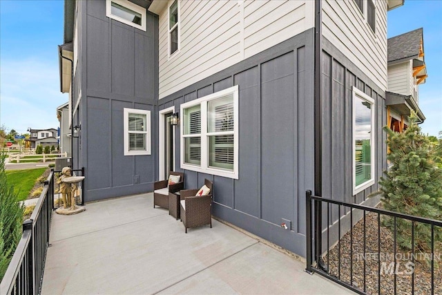 205 S Ripplerock Ln, Star, ID 83669 - view of property exterior featuring board and batten siding and a patio area