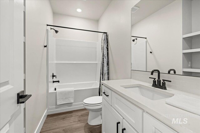 205 S Ripplerock Ln, Star, ID 83669 - bathroom featuring toilet, shower / bath combo, wood finished floors, vanity, and baseboards