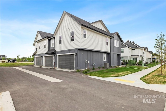 205 S Ripplerock Ln, Star, ID 83669 - view of side of property with board and batten siding, a residential view, an attached garage, central AC, and asphalt driveway