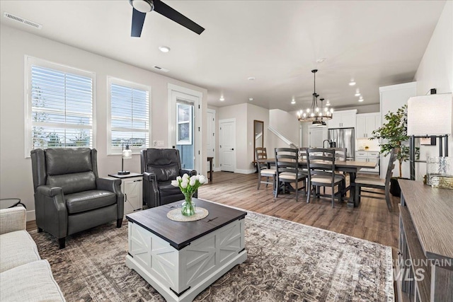 205 S Ripplerock Ln, Star, ID 83669 - living room with ceiling fan, a chandelier, dark wood-style flooring, baseboards, and recessed lighting