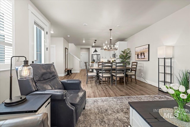 205 S Ripplerock Ln, Star, ID 83669 - living room featuring light wood-style floors, a chandelier, baseboards, and recessed lighting