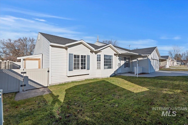 rear view of property with central AC and a yard