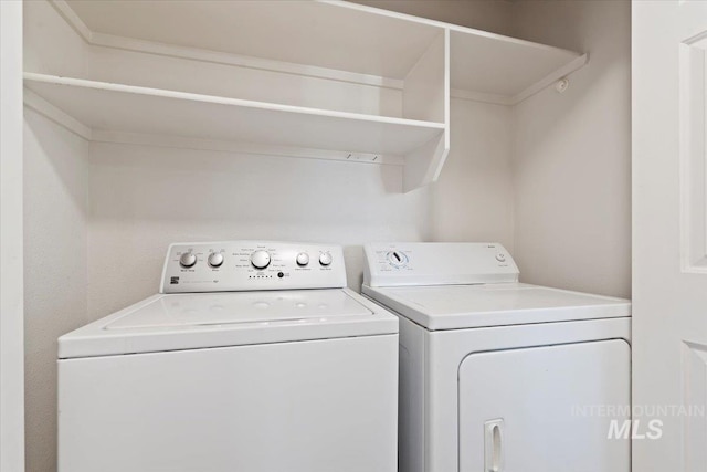 clothes washing area featuring washing machine and clothes dryer