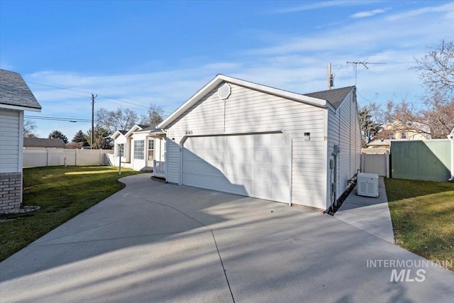 view of side of home featuring a lawn and a garage