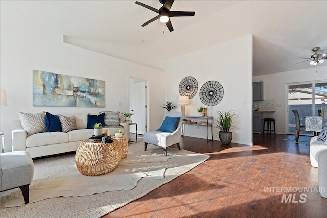 living room featuring ceiling fan and dark wood-type flooring