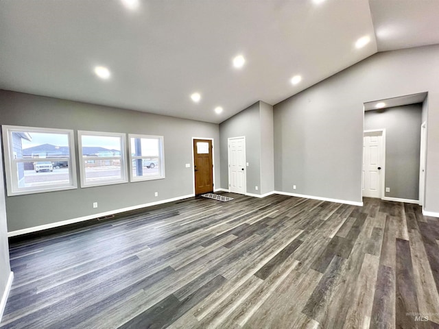 interior space featuring dark hardwood / wood-style flooring and lofted ceiling